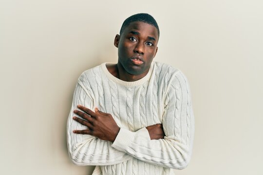 Young african american man wearing casual clothes shaking and freezing for winter cold with sad and shock expression on face