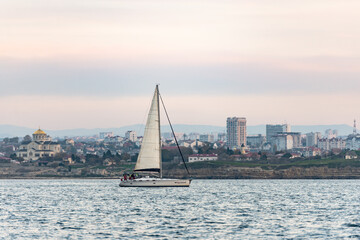Sevastopol. Crimea. Autumn 2020. The yacht enters the bay of Sevastopol. The yacht goes under the mainsai.