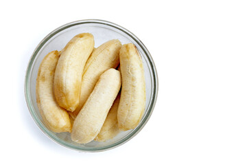 Peeled banana on glass bowl on white