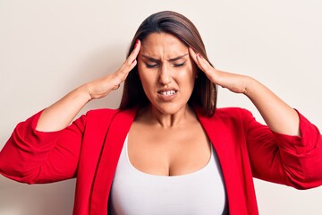 Young beautiful brunette woman wearing elegant jacket with hand on head, headache because stress....