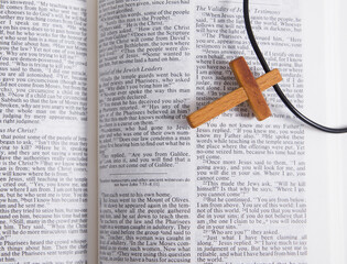Top view Wooden cross on an open bible. Christian religion concept