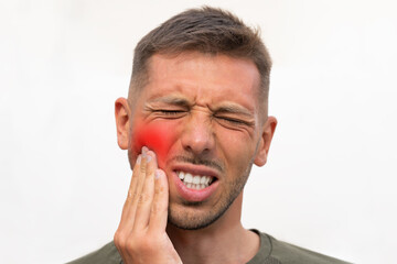 Man touching his cheek because of strong tooth pain with red highlighted area. Man suffering from toothache. Teeth problem. Man feeling tooth pain