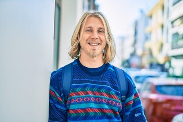 Young scandinavian student man smiling happy standing at the city.