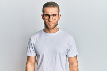 Young caucasian man wearing casual clothes and glasses skeptic and nervous, frowning upset because of problem. negative person.