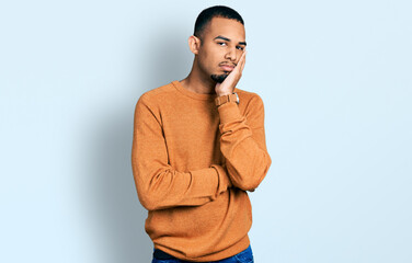 Young african american man wearing casual clothes thinking looking tired and bored with depression problems with crossed arms.