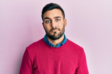 Obraz premium Young hispanic man wearing casual clothes looking sleepy and tired, exhausted for fatigue and hangover, lazy eyes in the morning.