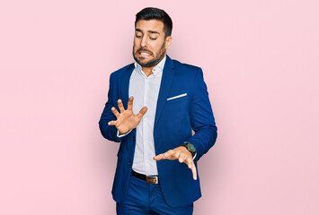 Young hispanic man wearing business jacket disgusted expression, displeased and fearful doing...
