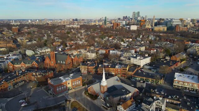 Brookline village commercial center at Harvard Street and Washington Street aerial view with Boston Back Bay skyline at the background in winter in town of Brookline, Massachusetts MA, USA. 