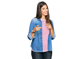 Young brunette woman wearing casual clothes pointing fingers to camera with happy and funny face. good energy and vibes.