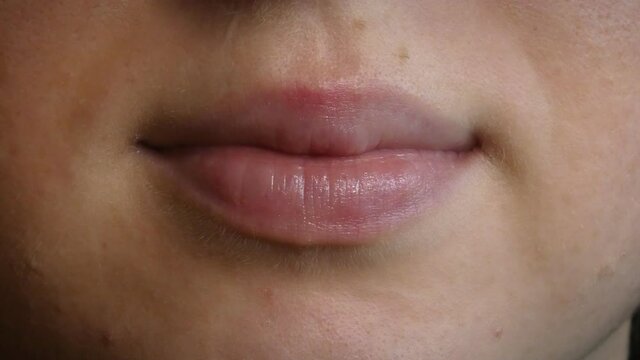 Detail of beautiful woman's lips, saying hello, talking gently, 4K detail