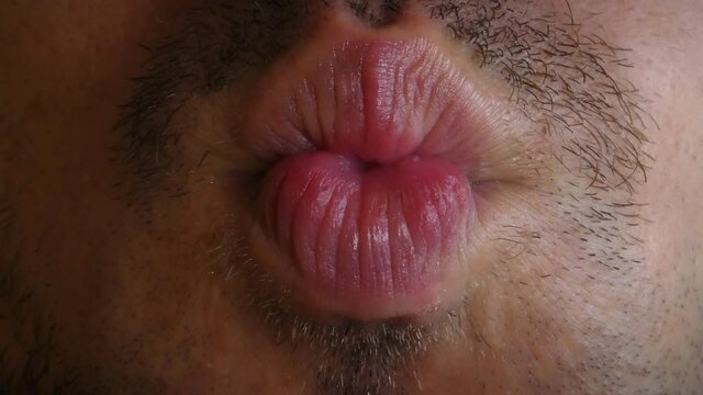 Detail of a man's mouth giving kiss, 4K detail