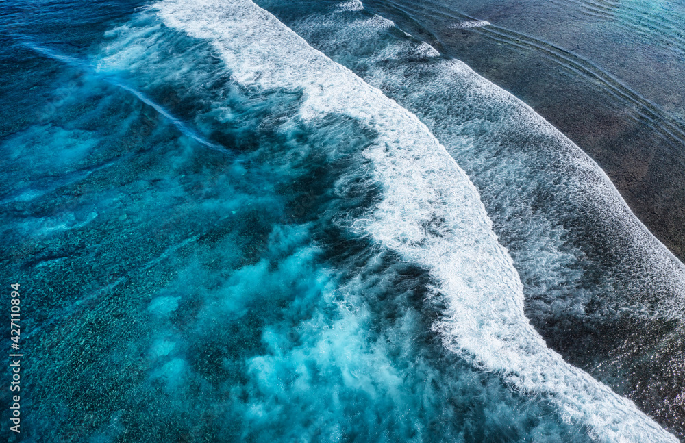 Wall mural coast with high waves as a background from top view. blue water background from top view. summer sea