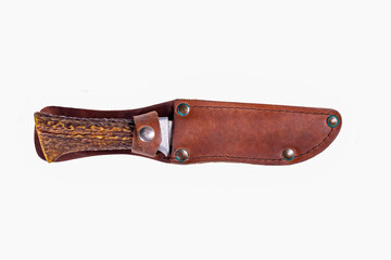 A hunting knife with a leather scabbard and a deer horn handle. Accessories for hunters hunting deer.
