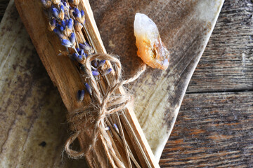 A top view image of several pieces of holy wood and healing crystals on a hand made pottery plate. 