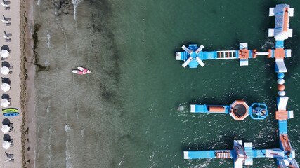 Aerial View Watersports, Sea Park, Inflatable Slides Floating On Surface Of The Sea Of Tropical Beach Drepanos In Igoumenitsa, Epirus, Greece.