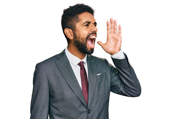 Young african american man wearing business clothes shouting and screaming loud to side with hand on mouth. communication concept.