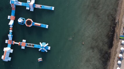 aerial view watersports, sea park, water fun activities,  floating slides on the surface of the sea...