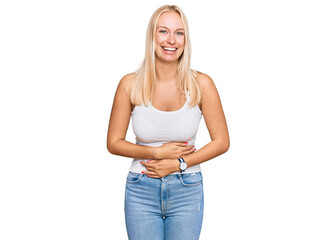 Young blonde girl wearing casual style with sleeveless shirt smiling and laughing hard out loud...