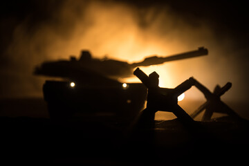 War Concept. Armored vehicle silhouette fighting scene on war foggy sky background at night....