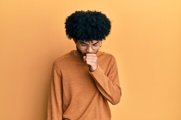 Fototapeta na wymiar Young african american man with afro hair wearing casual winter sweater feeling unwell and coughing as symptom for cold or bronchitis. health care concept.