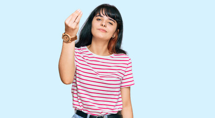 Young hispanic girl wearing casual clothes doing italian gesture with hand and fingers confident expression