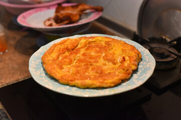 Closeup of a plate with a typical omelet. Picture have noise, Soft focus.