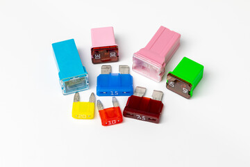 Assorted new vehicle blade fuses and cartridge fuses isolated on white background.  Concept of...
