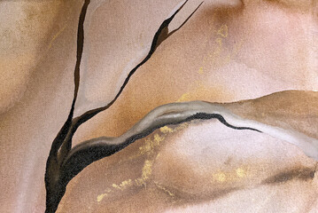 Abstract beige art with gold — pink background with brown, beautiful smudges and stains made with alcohol ink and golden pigment on canvas. Beige fluid art texture resembles watercolor or aquarelle.