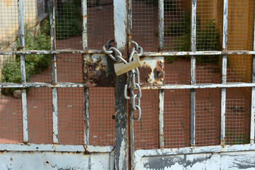 metal gate closed with chain and bolt