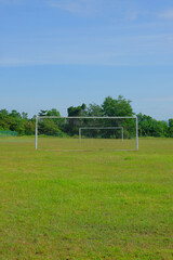 A piture of goal post and empty football field in the morning. Contact sport is not allow during Covid-19 pandemic