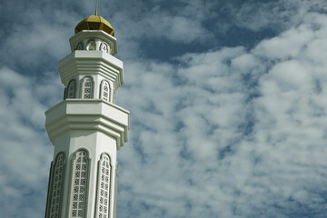 A picture of mosque minaret with beautiful cloud as background in the morning.
