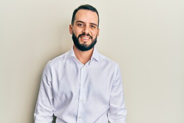 Young man with beard wearing business white shirt with a happy and cool smile on face. lucky person.