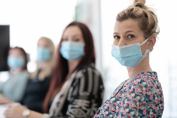 real business people on meeting wearing protective mask