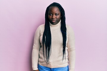 Young black woman with braids wearing casual winter sweater depressed and worry for distress, crying angry and afraid. sad expression.