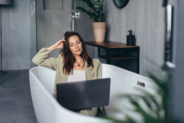 Woman secluded at home in the bathtub and works