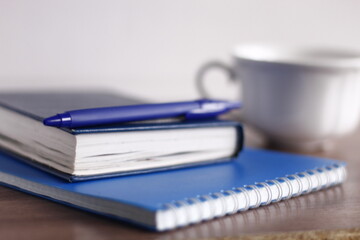 cup of coffee pen note and notebook office work