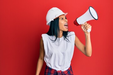 Young african american worker woman screaming using megaphone over isolated red background.
