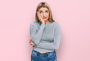 Young caucasian woman wearing casual clothes thinking looking tired and bored with depression problems with crossed arms.