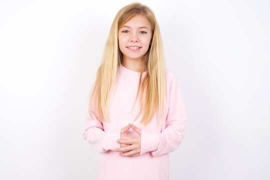 Business Concept - Portrait of beautiful caucasian little girl wearing pink hoodie over white background holding hands with confident face.