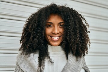 Young african american woman smiling happy standing at the city.