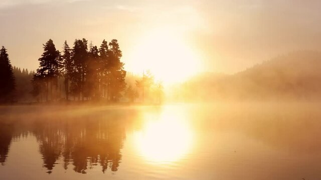 Morning fog over mountain lake, sunrise 4k aerial view