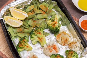 Baked in foil vegetables broccoli, green beans and cauliflower with spices and lemon. Vegan vegetarian healthy diet asian food