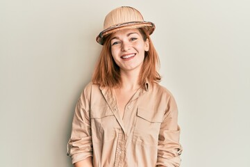 Young caucasian woman wearing explorer hat with a happy and cool smile on face. lucky person.
