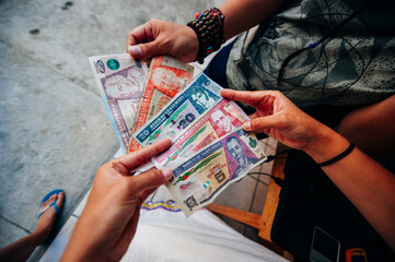 hands of a woman counting Guatemalan money