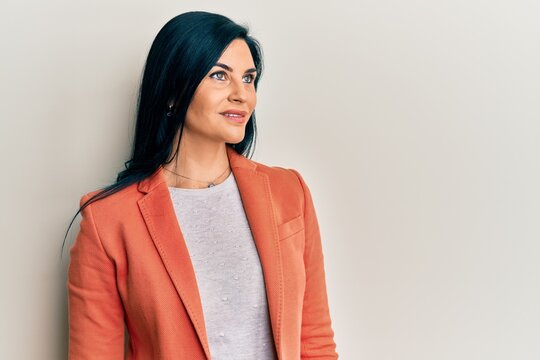 Young caucasian woman wearing business clothes looking to side, relax profile pose with natural face and confident smile.