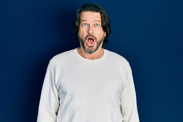 Fototapeta premium Middle age caucasian man wearing casual clothes afraid and shocked with surprise expression, fear and excited face.