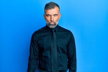 Middle age handsome man wearing business shirt and tie skeptic and nervous, frowning upset because of problem. negative person.