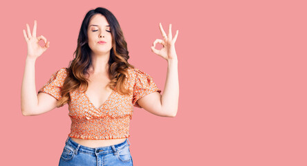 Beautiful young brunette woman wearing casual clothes relax and smiling with eyes closed doing meditation gesture with fingers. yoga concept.