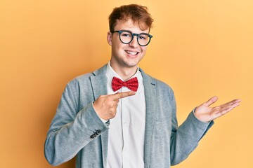 Young caucasian nerd man wearing glasses wearing hipster elegant look with bowtie amazed and...