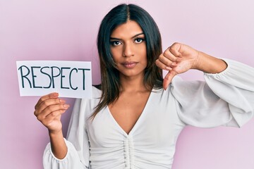 Young latin transsexual transgender woman holding respect message paper with angry face, negative...